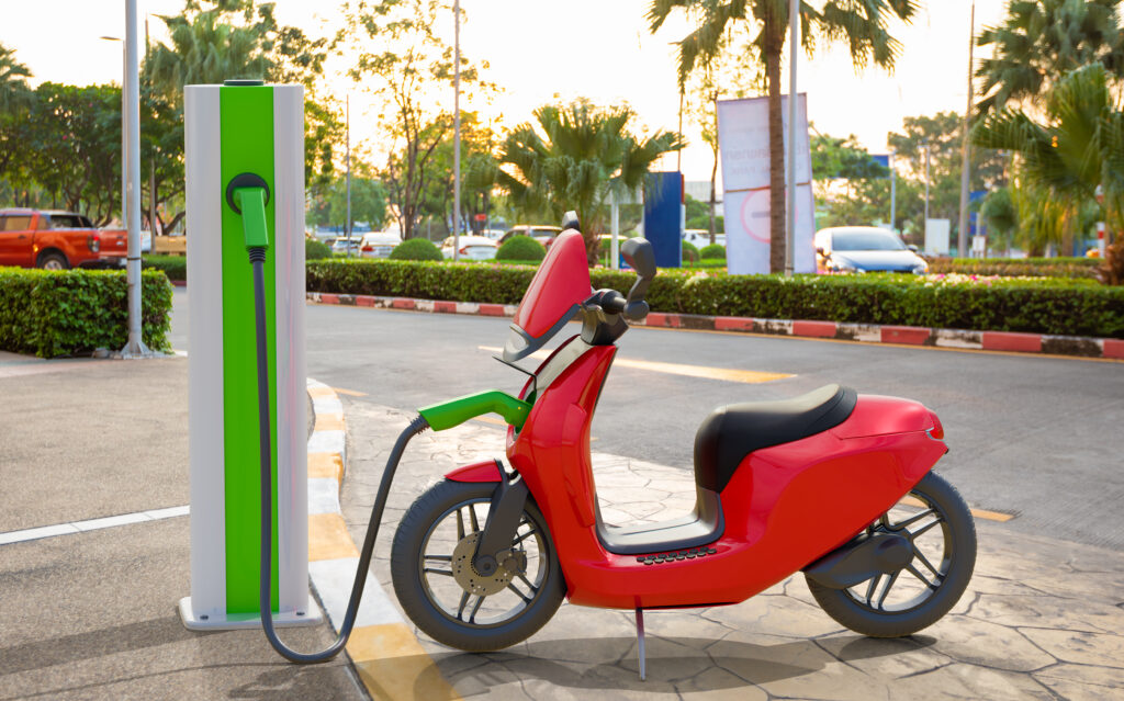 Energenic - An electric scooter charging at power station
